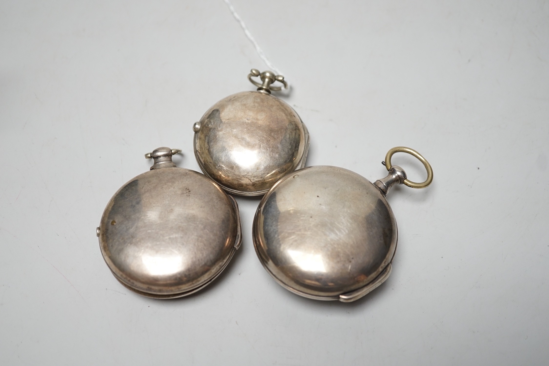 An 18th century silver pair cased keywind verge pocket watch, by Sam Toulmin, London, a similar watch by Tomlin, London and one other silver pair cased pocket watch with unsigned movement.